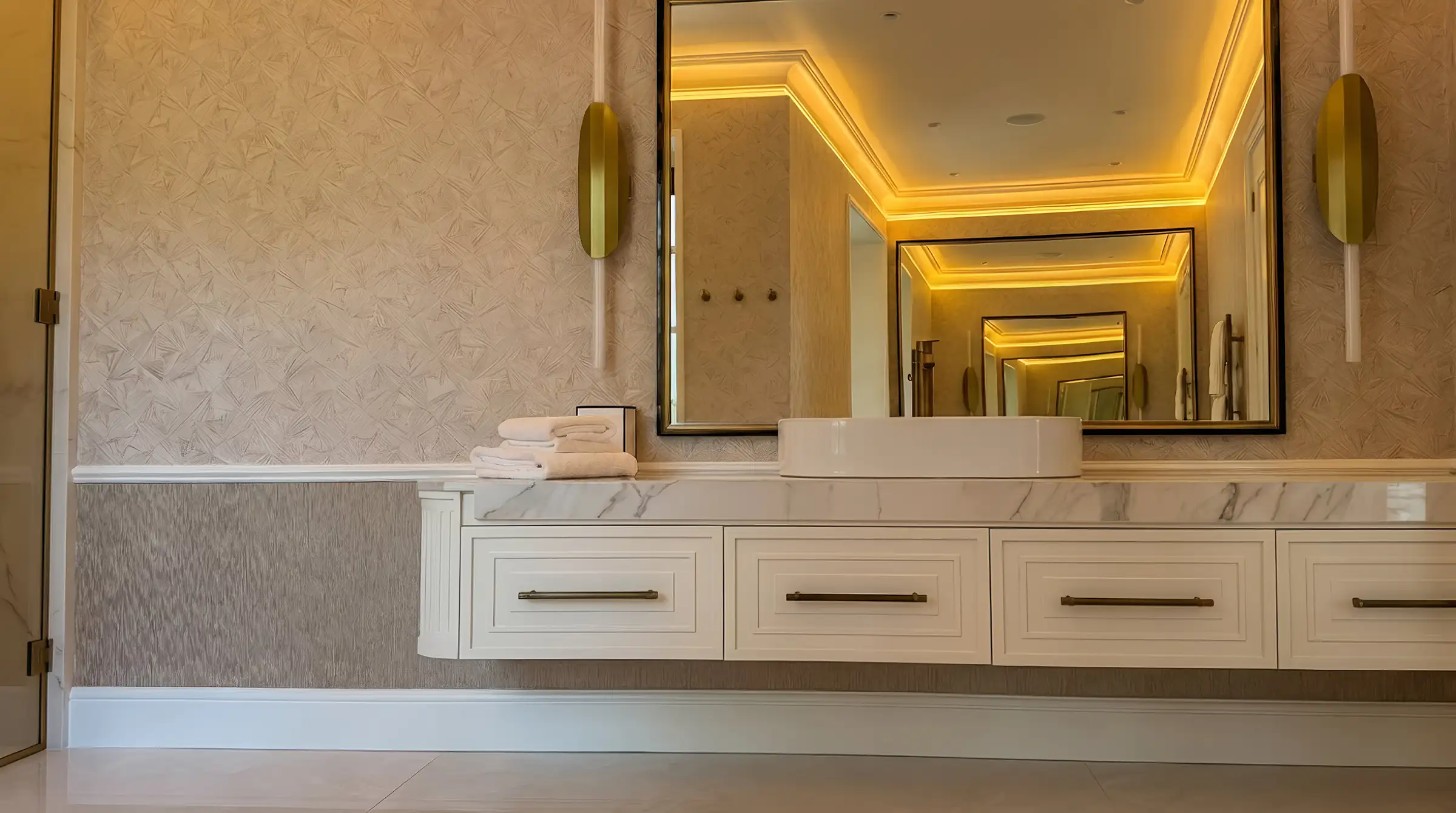 Double vanity in Calacatta porcelain with cove lighting
